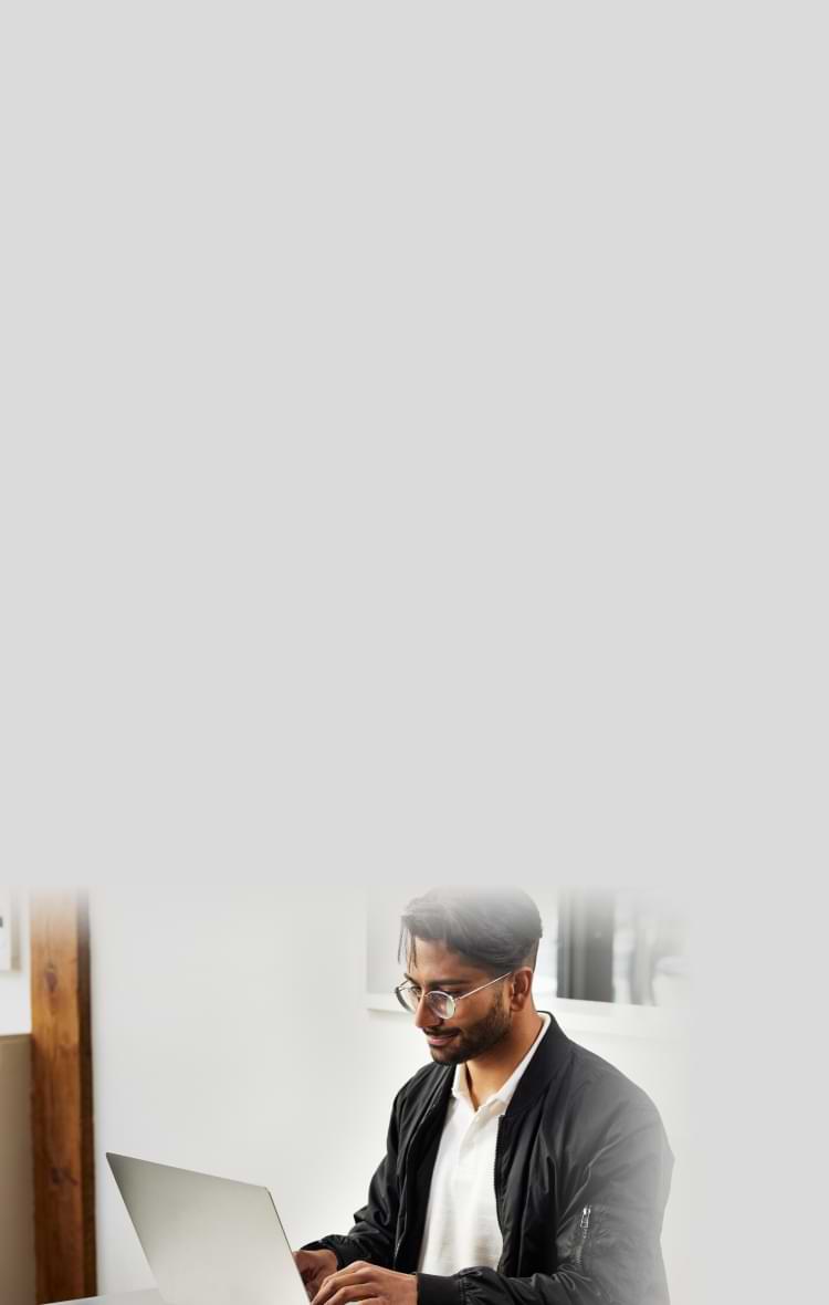 Man with a mug on a laptop.